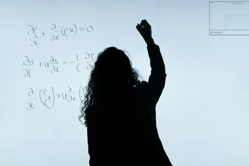A person writing a complex mathematics formula on a blackboard, illustrating the core of the calculation.