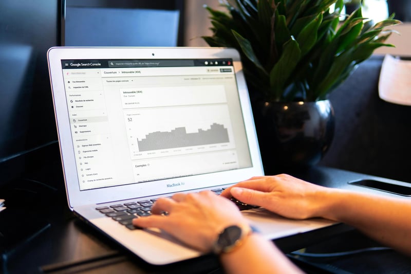 Person working with Excel spreadsheet on computer, implementing marketing formulas